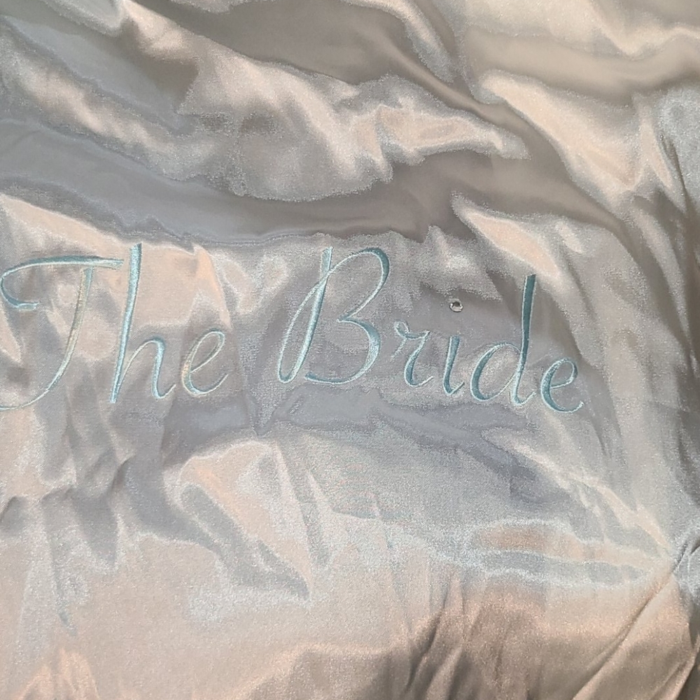 Satin robe with the word BRIDE on the back.